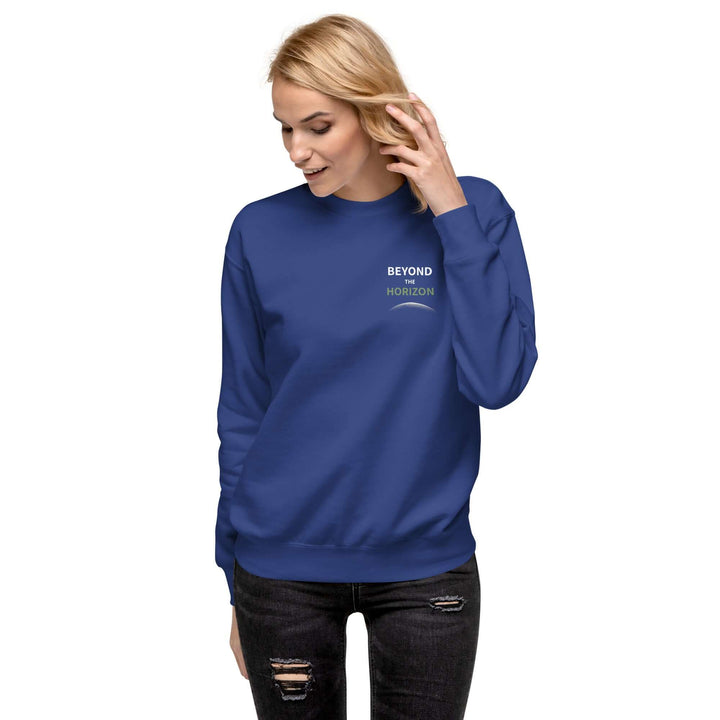 Beyond the Horizon Unisex Premium Sweatshirt in blue worn by a woman with a casual style.