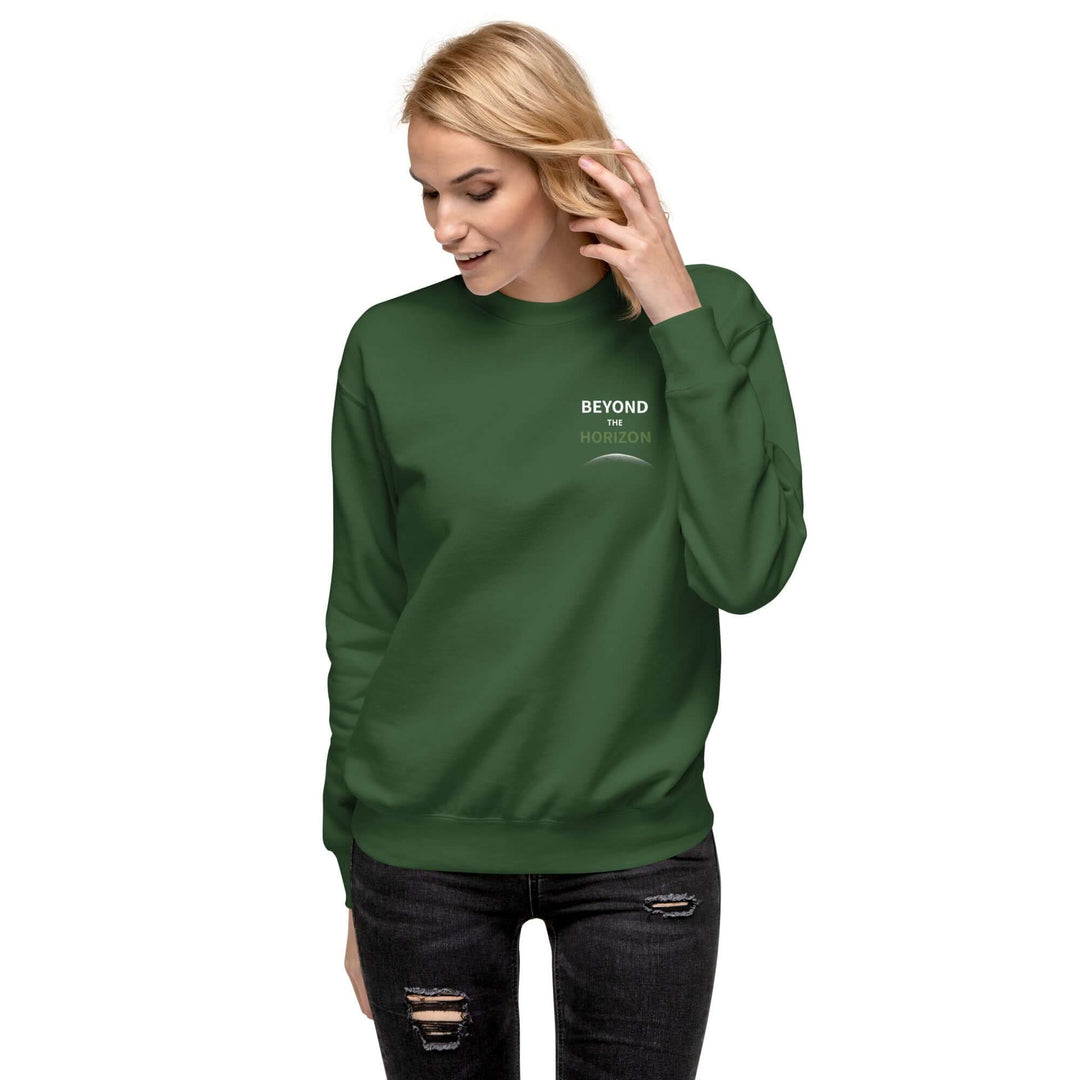 Beyond the Horizon Unisex Premium Sweatshirt in green worn by a smiling woman with long sleeves.