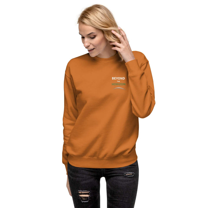 Beyond the Horizon Unisex Premium Sweatshirt in orange, featuring a classic silhouette and comfortable fit.