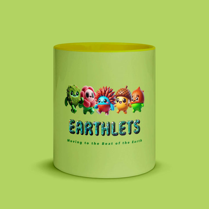 Colorful Earthlets mug featuring playful characters and a vibrant yellow inside, perfect for coffee or tea.