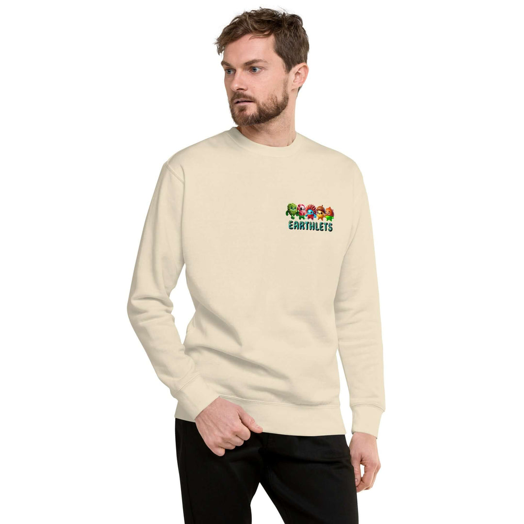 Man wearing an Earthlets unisex premium sweatshirt in beige, featuring a colorful logo on the front.