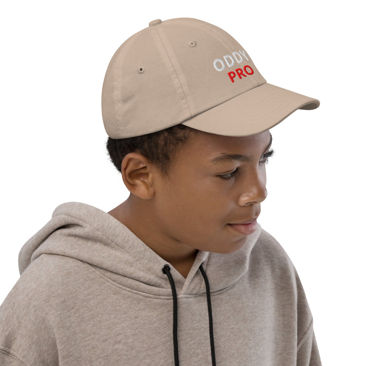 Oddy Pro Youth baseball cap worn by a boy, featuring an adjustable fit and stylish design.