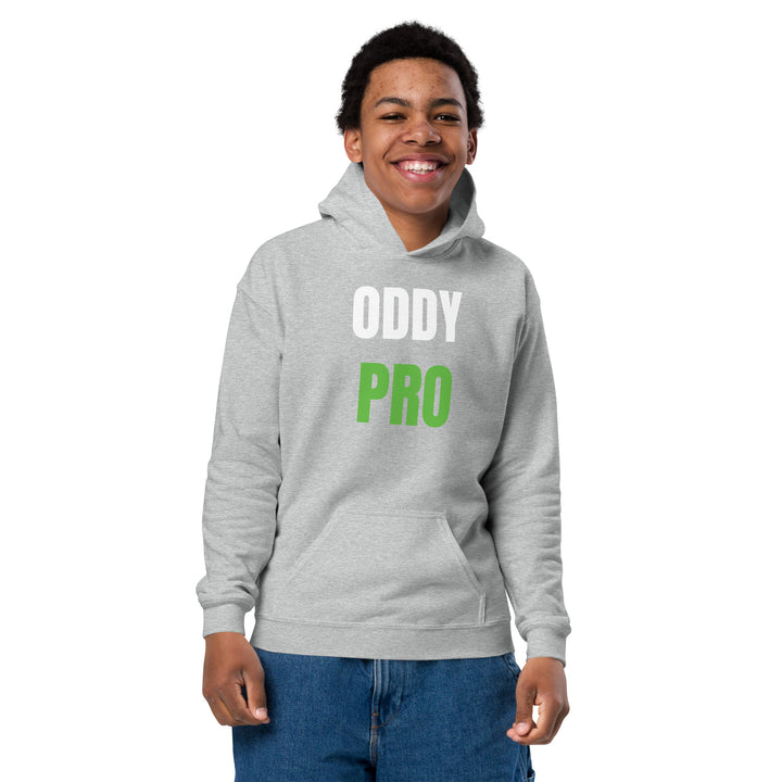 A smiling child wearing an Oddy Pro Youth heavy blend hoodie in gray, showcasing the vibrant printed design.