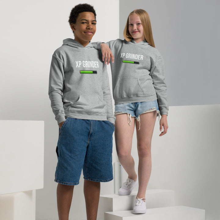 Two children wearing XP Grinder Youth heavy blend hoodie in gray, showcasing style and comfort.